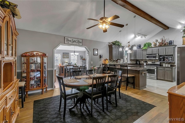 dining area featuring ceiling fan, beamed ceiling, light wood-style flooring, arched walkways, and high vaulted ceiling