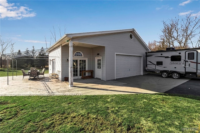 exterior space with a patio, driveway, and a front yard