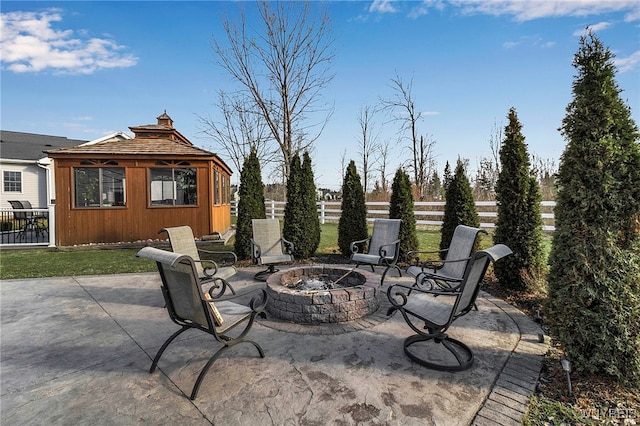 view of patio with a gazebo, a fire pit, and fence