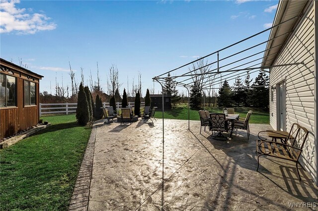 view of patio with outdoor dining space and fence