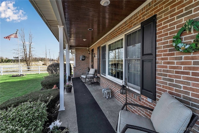 view of patio / terrace featuring covered porch and fence