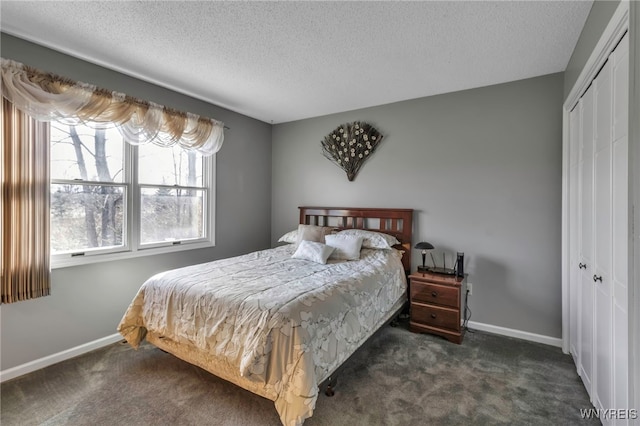 carpeted bedroom with baseboards, a closet, and a textured ceiling