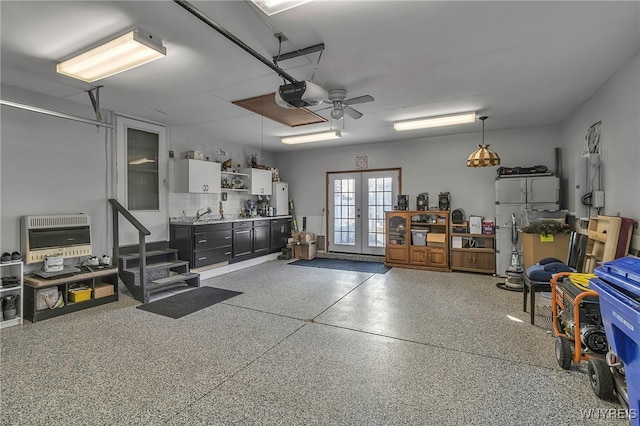 garage with heating unit, french doors, and a garage door opener