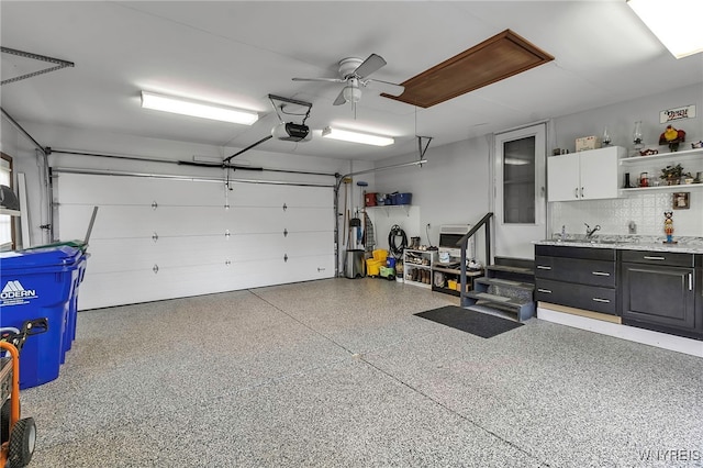 garage with a garage door opener and ceiling fan