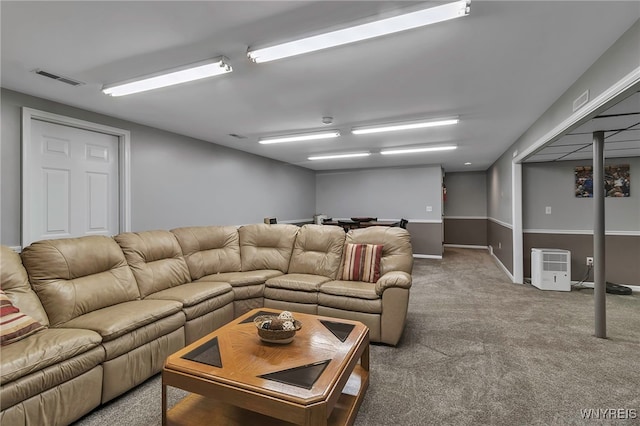 living area with visible vents and carpet