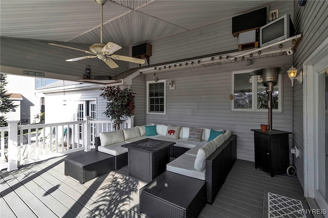 deck featuring an outdoor living space with a fire pit and a ceiling fan