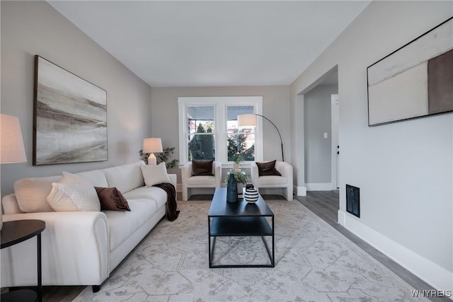 living area featuring visible vents and baseboards