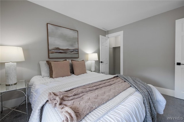 bedroom with a closet, carpet flooring, and baseboards