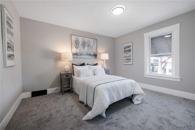 carpeted bedroom with visible vents and baseboards