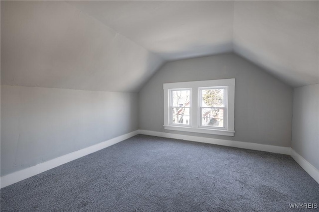 bonus room featuring baseboards, lofted ceiling, and carpet floors