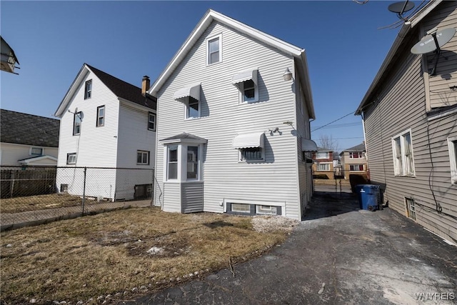 rear view of house with fence