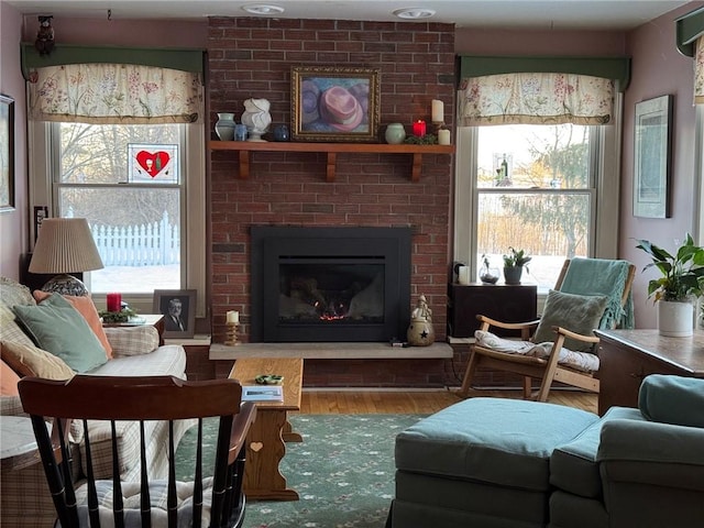 living area with a fireplace and wood finished floors