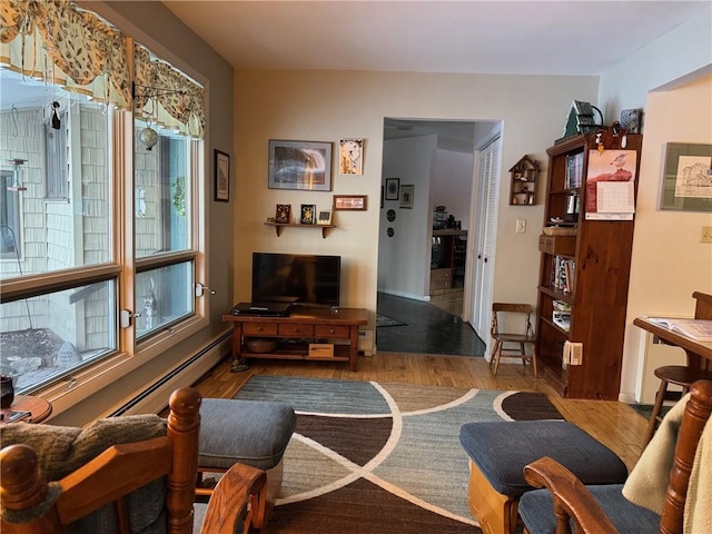 living room with a baseboard radiator and wood finished floors