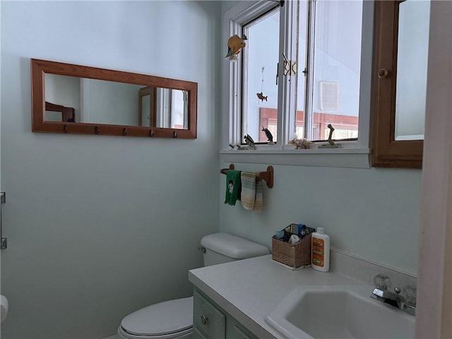 half bathroom with toilet and vanity