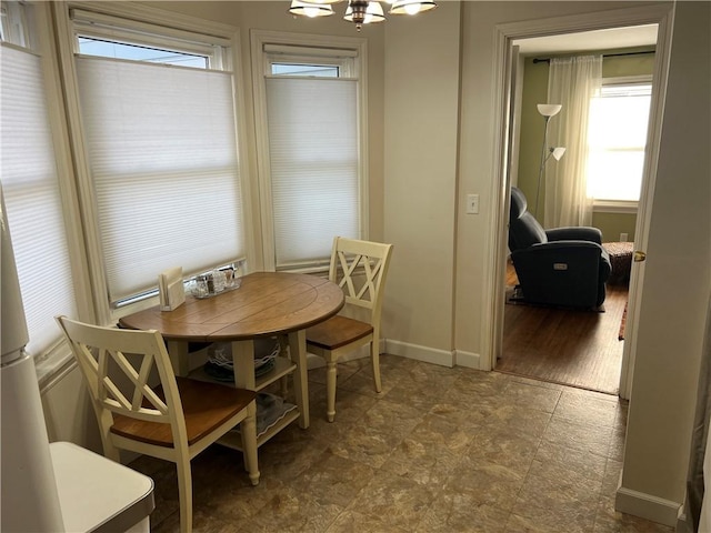 dining area with a notable chandelier and baseboards