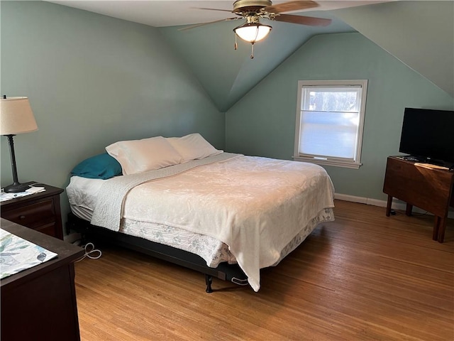 bedroom with lofted ceiling, a ceiling fan, light wood-type flooring, and baseboards