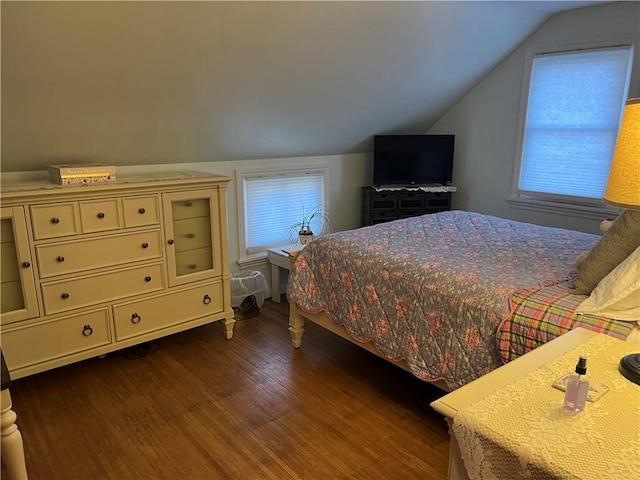 bedroom featuring lofted ceiling and wood finished floors