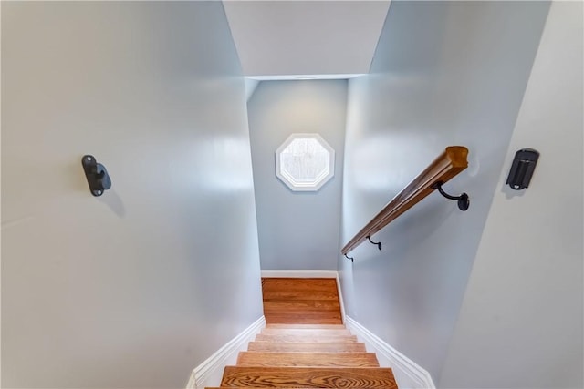 stairs featuring baseboards and wood finished floors