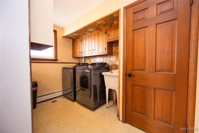 laundry room with cabinet space, independent washer and dryer, light floors, and a baseboard radiator