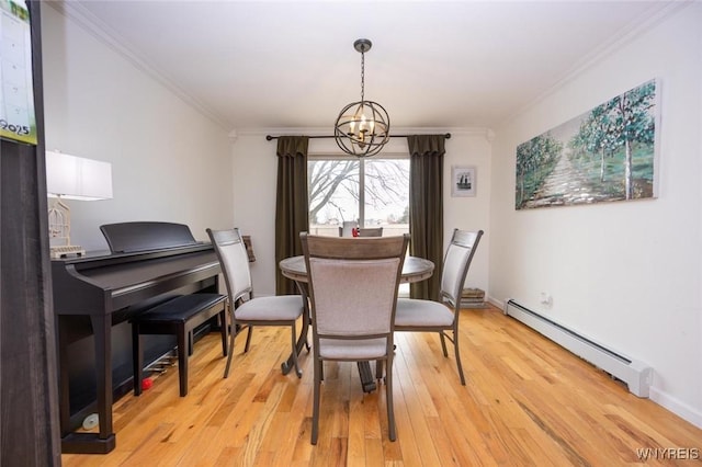 dining room with a notable chandelier, baseboard heating, light wood-style flooring, and crown molding