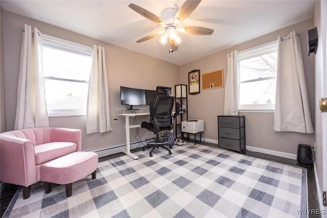 home office with a baseboard heating unit, baseboards, and ceiling fan