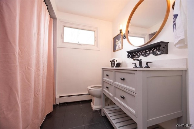 bathroom with tile patterned floors, baseboard heating, vanity, and toilet