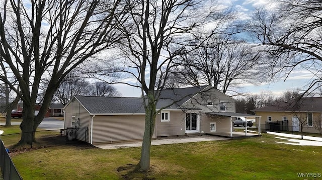 rear view of property featuring a patio, a yard, and fence