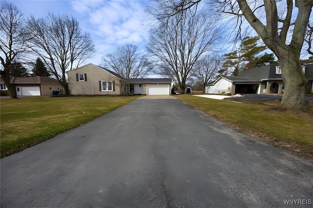 view of front of house with a garage, driveway, and a front yard