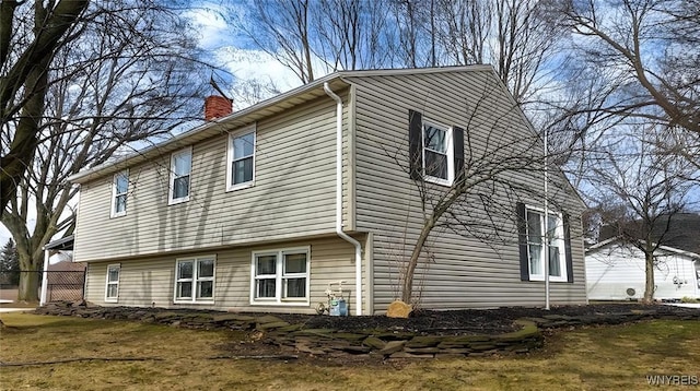 view of property exterior with a chimney