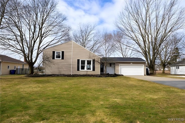 view of front of house with an attached garage, concrete driveway, a front yard, and fence