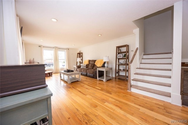 living area featuring recessed lighting, light wood-type flooring, and stairs