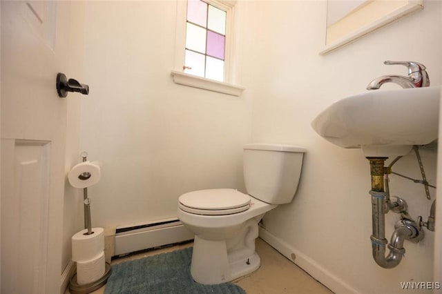 bathroom with baseboards, baseboard heating, and toilet