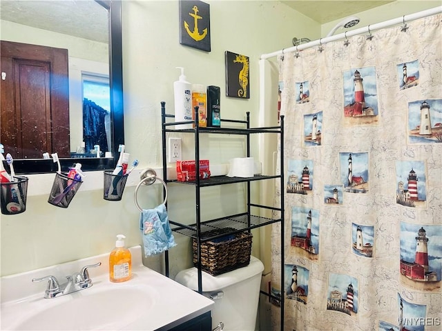 bathroom with a sink, a shower with curtain, and toilet