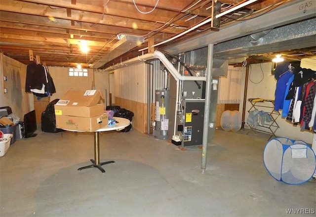 below grade area featuring heating unit and water heater