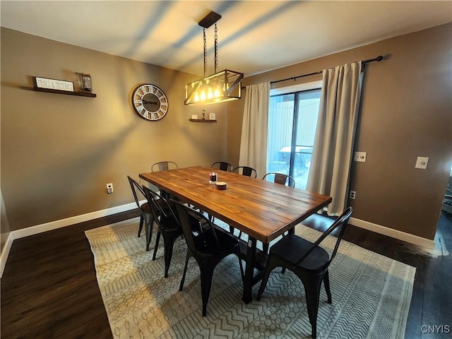 dining room featuring baseboards and dark wood-type flooring