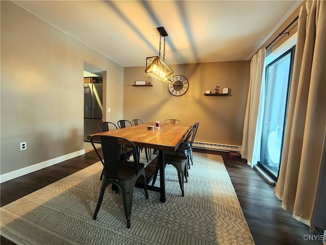 dining space with a baseboard radiator, a healthy amount of sunlight, and dark wood finished floors