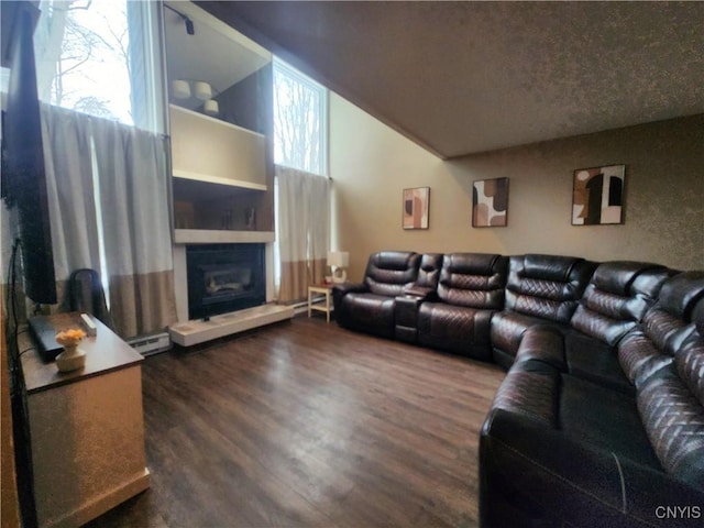 living room with a fireplace with raised hearth, dark wood-style flooring, and high vaulted ceiling