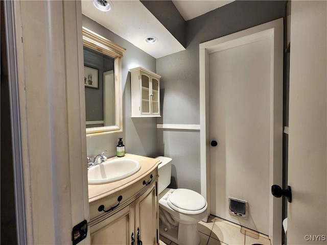 bathroom featuring vanity, tile patterned floors, and toilet