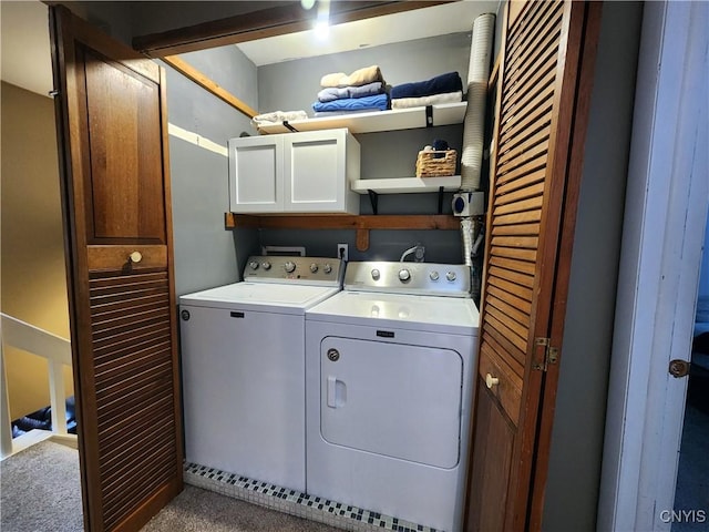 clothes washing area with carpet, separate washer and dryer, and cabinet space