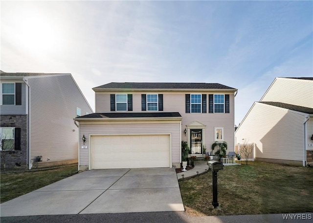 view of front facade with an attached garage, concrete driveway, and a front lawn