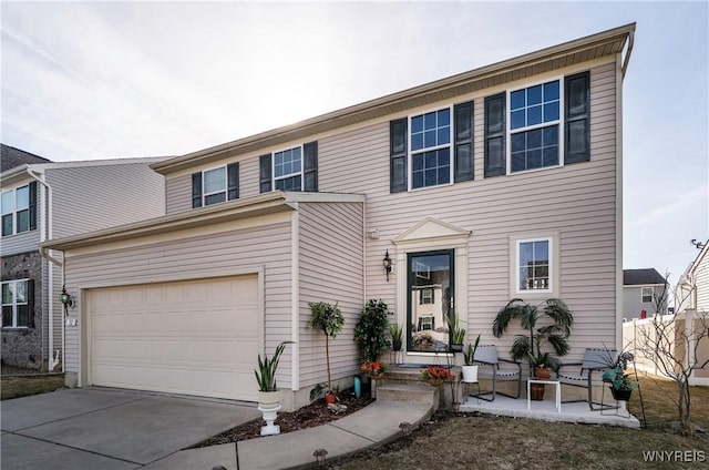 view of front of property featuring concrete driveway and an attached garage