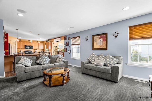 living room featuring visible vents, recessed lighting, dark carpet, and baseboards