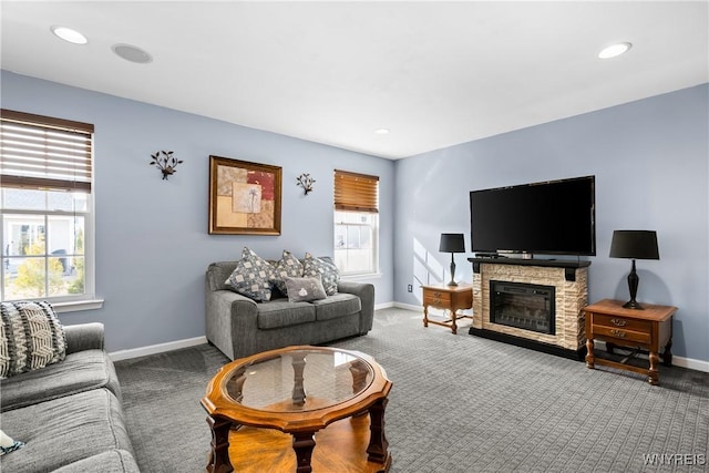 carpeted living area featuring a wealth of natural light, baseboards, a fireplace, and recessed lighting