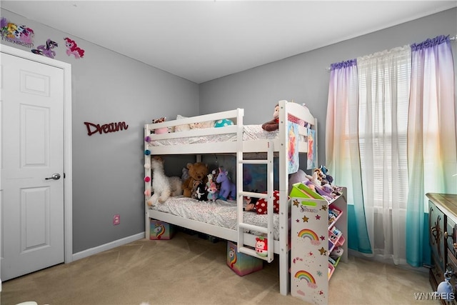 bedroom featuring baseboards and carpet