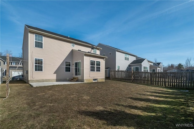 rear view of property featuring a patio area, a lawn, entry steps, and fence