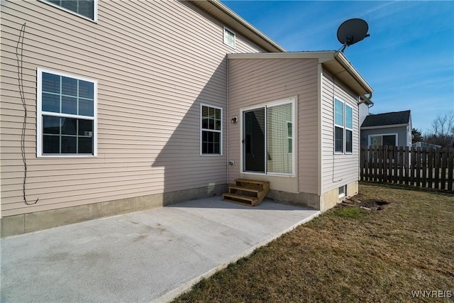 entrance to property featuring a patio area and fence