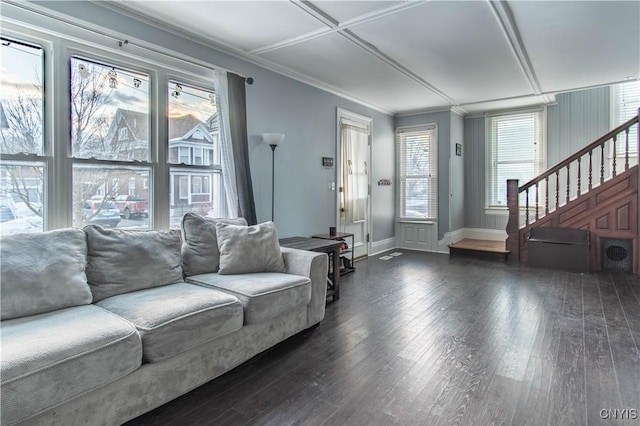 living room with baseboards, dark wood-type flooring, ornamental molding, and stairs