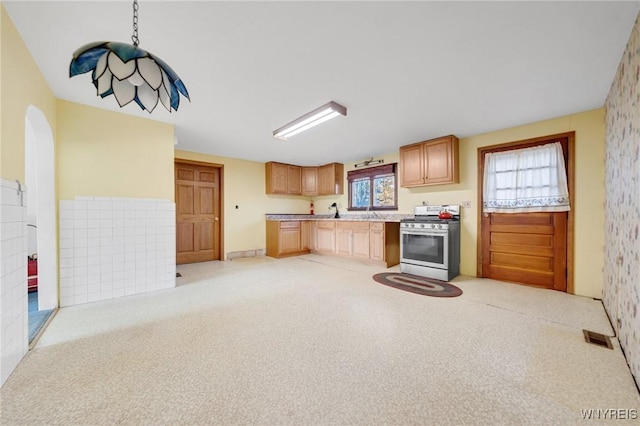 kitchen with visible vents, light countertops, and stainless steel range with gas cooktop