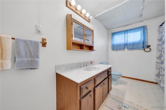 bathroom featuring tile patterned floors, toilet, curtained shower, baseboards, and vanity