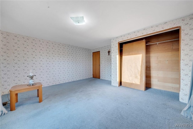 unfurnished bedroom with carpet floors and wallpapered walls